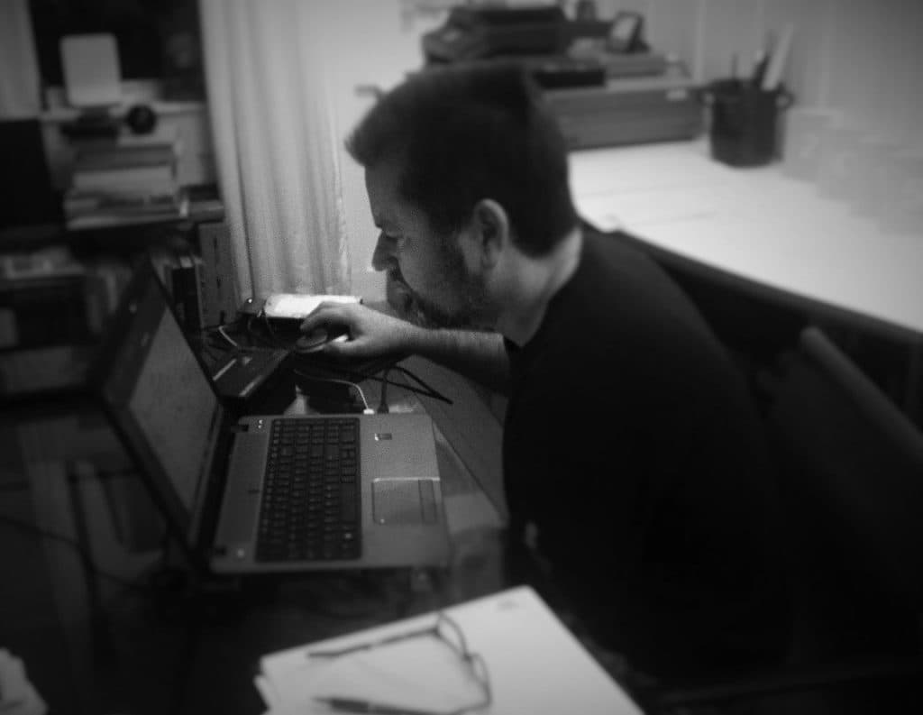 A person working intently at a laptop