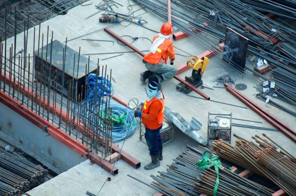 Construction workers building on a steel-framed foundation