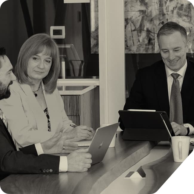 Business colleagues meeting at a table with laptops