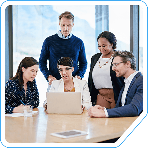 A team collaborating around a laptop
