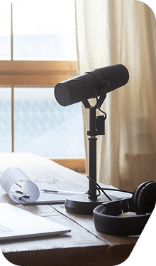 A studio podcast microphone on a desk