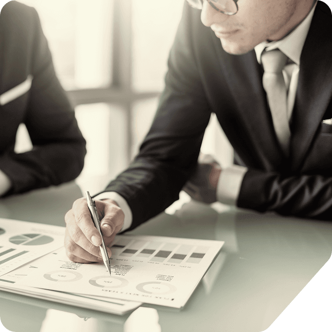 A leader reviewing charts and financial documents at a desk